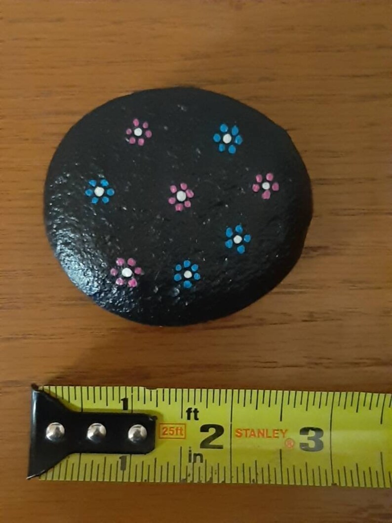 Handpainted flowers on river rock