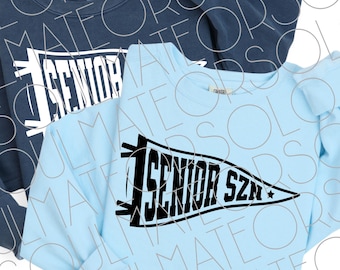 May include: Two long-sleeved sweatshirts, one navy blue and one light blue. The light blue sweatshirt has a black pennant design that reads "1 SENIOR SZN". The navy blue sweatshirt has the word "SENIOR" in white.