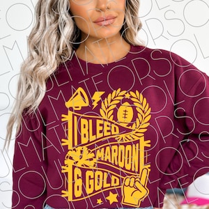 May include: Maroon sweatshirt with a gold graphic that reads "I Bleed Maroon & Gold." The design includes a megaphone, lightning bolt, football, and a hand giving the number one sign. A great gift for a sports fan.