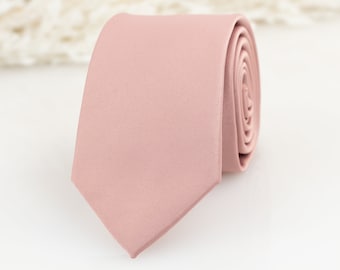 May include: A solid dusty rose pink necktie. The tie is made of a smooth satin fabric.