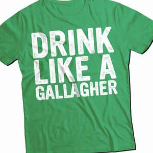 May include: Green t-shirt with white text that reads "Drink Like A Gallagher".