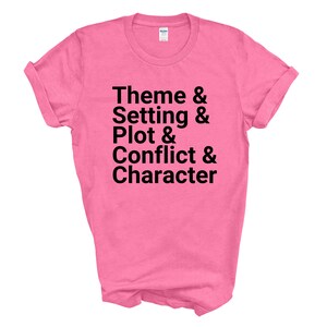 May include: Pink t-shirt with black text that reads "Theme & Setting & Plot & Conflict & Character"