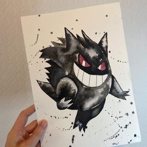 May include: Watercolor painting of a Gengar character in black and gray tones with red eyes and a wide grin. The artwork features splattered ink effects on a white background, creating a dynamic and expressive illustration.