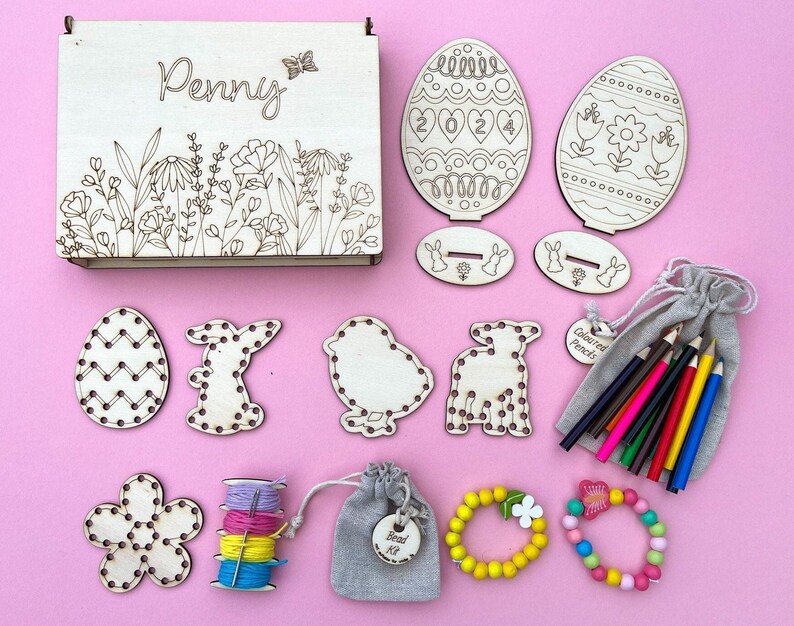 Personalised Wooden Easter Box -19.5cm x 14.5cm x 3cm.5 wooden embroidery shapes, 4 colours of cotton thread, 1 metal needle, 2 wooden easter egg shapes on a base, 12 colouring pencils, wooden bead kit to make 2 bracelets.