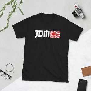 May include: Black t-shirt with white text that says "JDM" and a red and white Japanese flag.