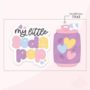 May include: A die-cut sticker featuring a purple soda can with heart accents and a straw, next to text that reads "my little soda pop." The sticker fits a 17.8 x 10.9 cm box. The design includes pink, yellow, and blue colours.