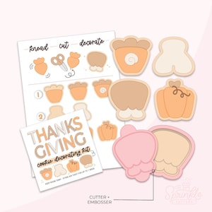 May include: A Thanksgiving cookie decorating kit with cookie cutters and an embosser. The kit includes a guide with instructions and illustrations for decorating cookies. The cookie cutters are in the shapes of pumpkins, gourds, and other fall-themed shapes. The kit is on a light pink background.