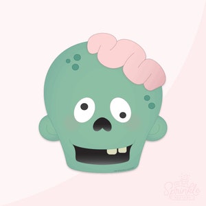 May include: A cartoon zombie head with a teal face, pink brain, and a tooth missing. The zombie has a black nose and mouth, and two white eyes. The image has the text "THE SPRINKLE FACTORY" and a logo in the bottom right corner.