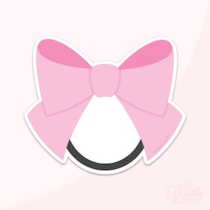 May include: A light pink bow with a black headband. The bow is a classic shape with a white outline. The image is on a light pink background. The Sprinkle Factory logo is in the bottom right corner.