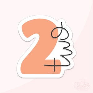 Puede incluir: Una pegatina de color melocotón con el número "2" y un diseño de espiral negro. La pegatina tiene el texto "The Sprinkle Factory" en la parte inferior.