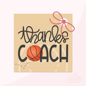 May include: A brown card with the text "thanks coach" in black script. A basketball is in the middle of the text. The card has a red ribbon tied around it.