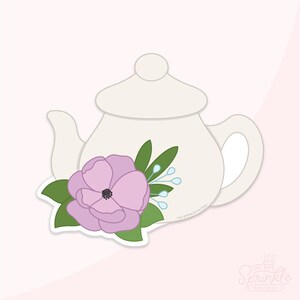 Peut inclure: Emporte-pièce en forme de théière blanche avec un motif floral. La théière a un couvercle et une poignée, et est décorée d'une fleur lavande, de feuilles vertes et d'accents bleus. Le design est sur fond rose.