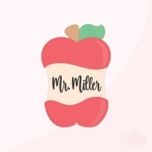 May include: A red apple with a bite taken out of it. The apple has a green leaf on top and the words "Mr. Miller" written on the inside of the bite.