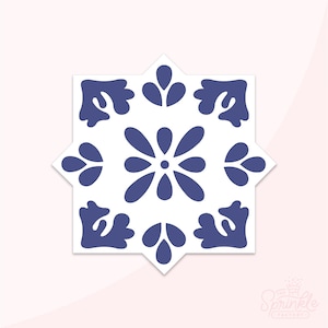 May include: A blue and white tile with a geometric pattern. The tile has a star shape with a central flower design.