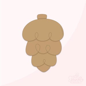 May include: A tan-colored cookie cutter in the shape of a pinecone. The cookie cutter has a rounded top and a layered design, with each layer having a looped detail. The background is a soft pink.