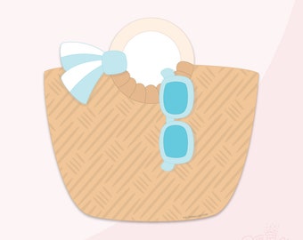 Könnte beinhalten: Eine braune Korbstrandtasche mit einer blauen Schleife und einer blauen Sonnenbrille. Die Tasche hat einen weißen Kreis in der Mitte.