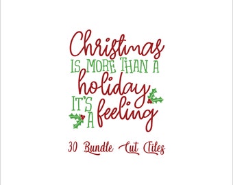 May include: Red cursive text on a white background reads "Christmas is more than a holiday it's a feeling".  Green holly leaves with red berries are on either side of the text.  The text "30 Bundle Cut Files" is below the main text.