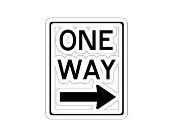 May include: A rectangular sticker featuring a white background with a black border. The text ONE WAY is printed in bold black capital letters, positioned above a solid black arrow pointing to the right. The design has a clean, graphic style.