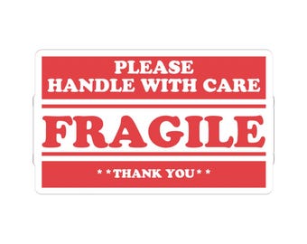 May include: A rectangular sticker with a red background and white text. The text reads PLEASE HANDLE WITH CARE, FRAGILE, and **THANK YOU**. The design features horizontal white lines separating the text sections, creating a clear warning label.