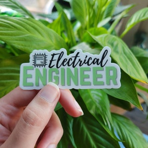 May include: A sticker with the words "Electrical ENGINEER" in black and light green. The word "ENGINEER" is in a light green block. Above the word "Electrical" is a black graphic of a circuit board.