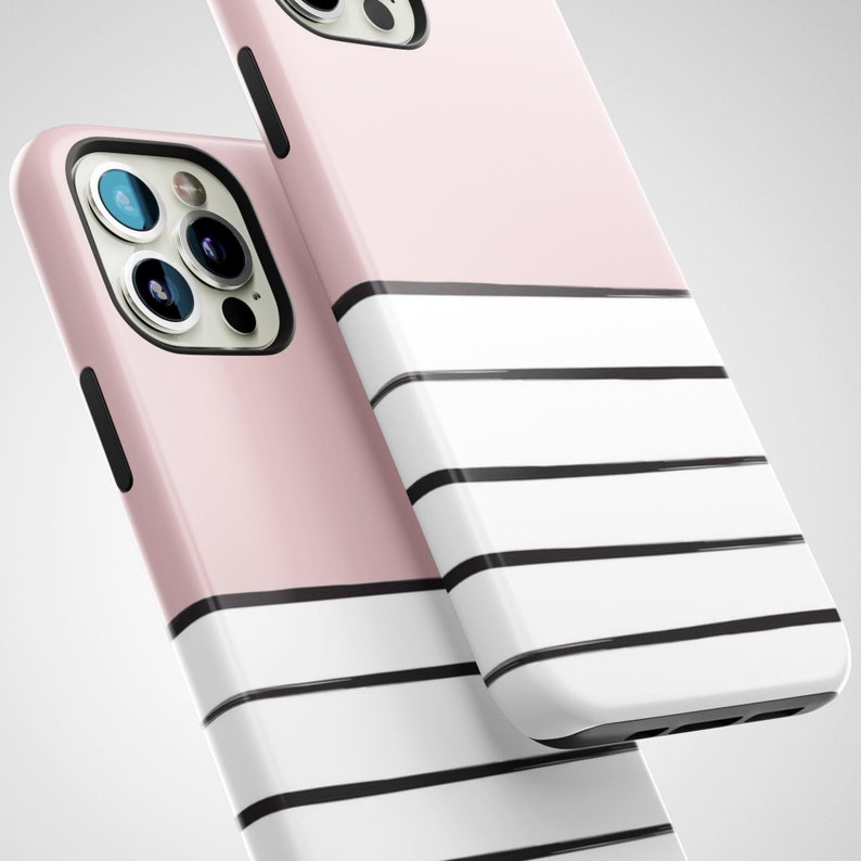 May include: Two pink and white striped phone cases with black stripes. The cases are designed for a smartphone with a camera bump.