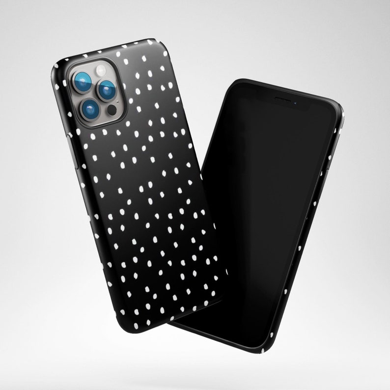 May include: A black phone case with a white polka dot pattern. The case is shown with a black phone with a blank screen.
