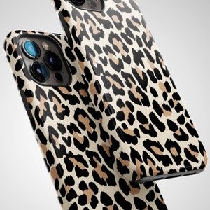 May include: Two iPhone cases featuring a leopard print design. The cases are black and brown with a white background.