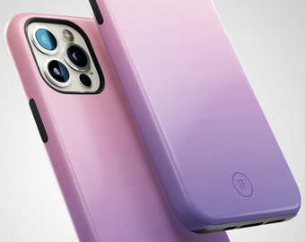 May include: Two phone cases with a gradient design. The top case is a light purple to dark purple gradient. The bottom case is a light pink to dark purple gradient. Both cases have a black button and a black camera cutout. The top case has a small circle with the letters "TF" in the center.