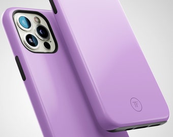 May include: Two lilac-colored phone cases with a black trim. The case on top has a small circle with the letters "TF" in white. The case on the bottom has a camera lens cutout.