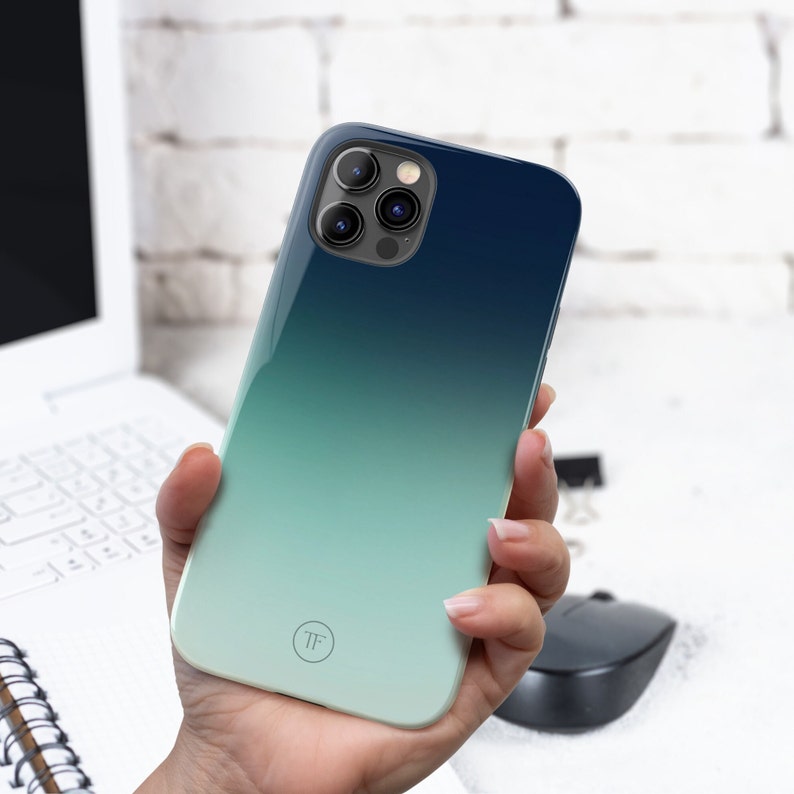 May include: A blue and green gradient phone case with a circular logo that says "TF".
