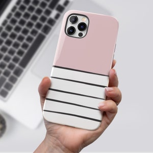 May include: A pink and white striped phone case with a black camera lens.