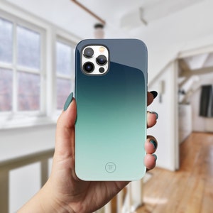 May include: A blue and green gradient phone case with a circular logo that says "TF".