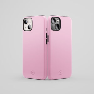 May include: Two pink phone cases with black trim and a camera lens cutout. The cases have a small circle with the letters "TF" in the center.