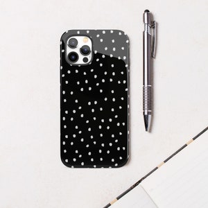 May include: Black phone case with a white polka dot pattern.