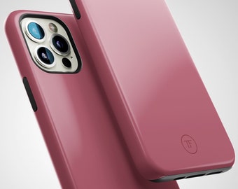 May include: Two pink phone cases with a black trim. The case on top has a small circle with the letters "TF" inside. The case on the bottom has a camera lens cutout.