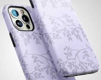 May include: Two lavender phone cases with a gray leaf branch pattern. The cases have black edges and are angled towards the viewer, showcasing the camera lenses and overall design. The cases are glossy and reflect light.