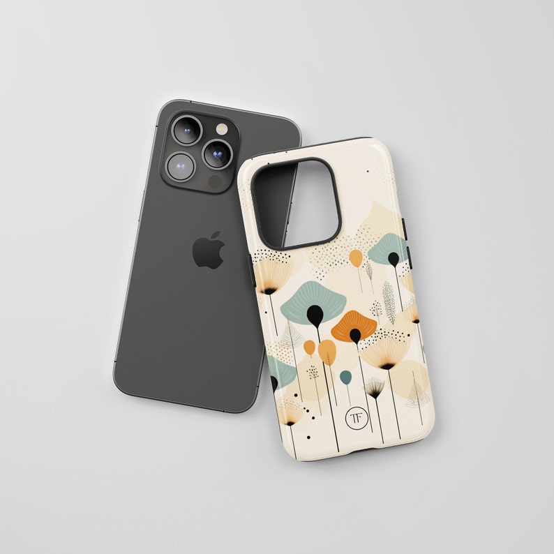 K&ouml;nnte beinhalten: Eine wei&szlig;e Handyh&uuml;lle mit einem Blumendesign mit abstrakten Blumen in Blau-, Orange- und Gelbt&ouml;nen. Die H&uuml;lle hat einen schwarzen Rand und einen kleinen schwarzen Kreis mit den Buchstaben "TF" in Wei&szlig;.