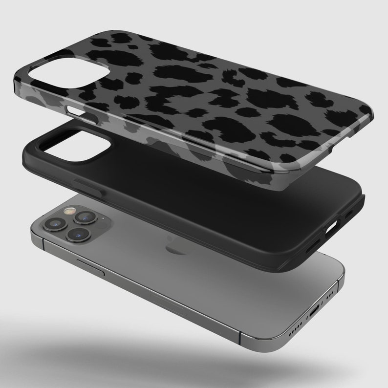 May include: A layered phone case with a gray leopard print design. The case is shown in three separate pieces, with the phone visible at the bottom. The top layer has a glossy finish, while the middle layer is black.
