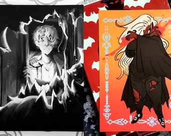 May include: Two art prints. One is a black and white illustration of a person looking out a window. The other is a colorful illustration of a figure with long white hair and a black cloak, with red accents and a decorative border.