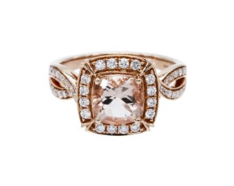 May include: A rose gold ring with a cushion-cut morganite center stone surrounded by a halo of round brilliant diamonds. The band features a delicate, twisted design.