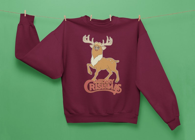 May include: Burgundy sweatshirt with a cartoon reindeer wearing glasses and the text "Merry Crismas".