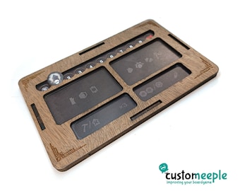 May include: A wooden game organiser with compartments for game pieces, dice, and tokens. The organiser has a brown wood finish and is engraved with the text "x3" and "7/" along with symbols.