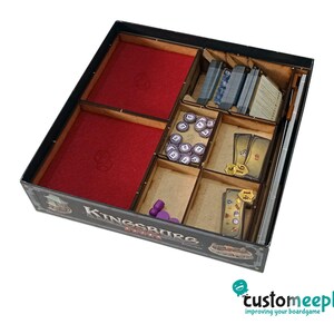 May include: A wooden game organiser insert for the board game Kingsburg. The insert has compartments for storing game components, including dice, cards, and tokens. The insert is made of wood and has a black finish.