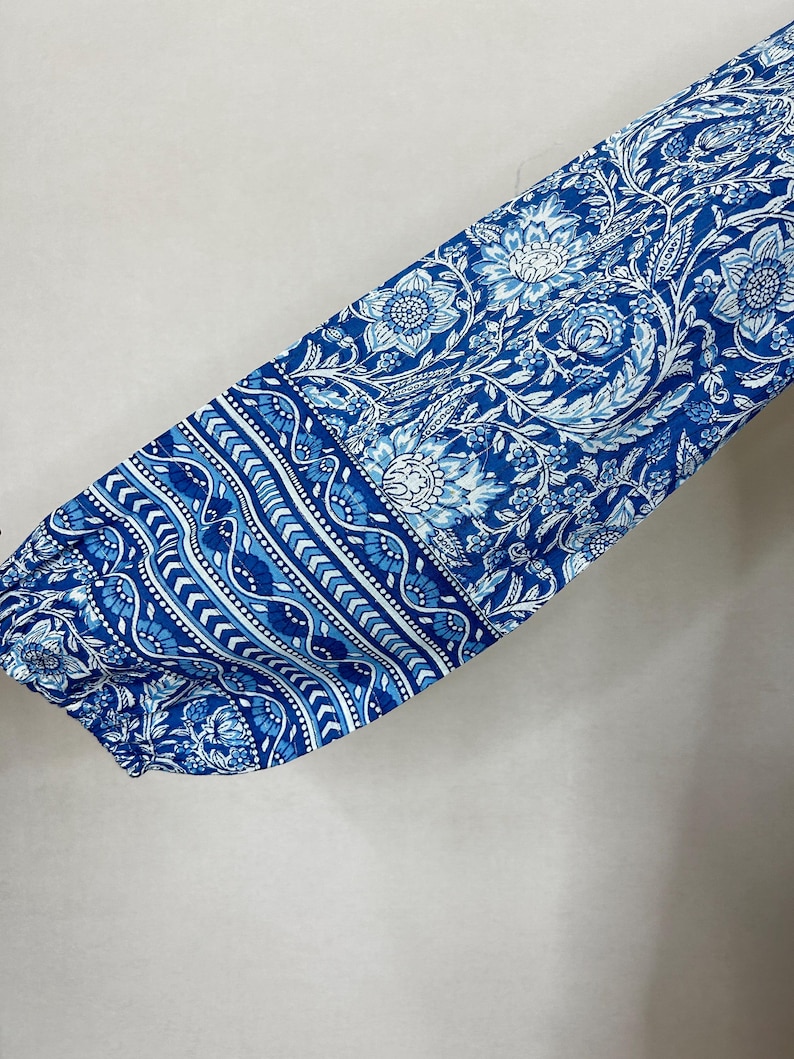 May include: Blue and white floral fabric with a geometric pattern. The fabric is soft and flowing, making it perfect for a variety of sewing projects.