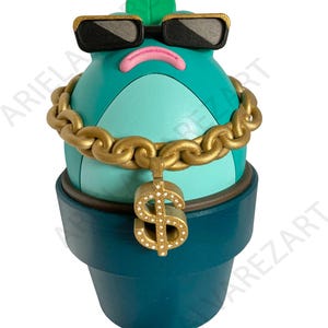 May include: A teal-colored, anthropomorphic plant figure wearing black sunglasses, a gold chain with a dollar sign pendant, and a green leaf. The figure is in a teal pot.