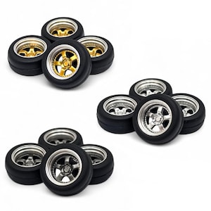 May include: A collection of miniature car tires with black rubber and metallic rims. One set features gold rims, while the other two sets have silver rims. The tires are arranged in small groups against a white background.
