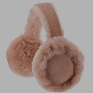 May include: A pair of soft, plush earmuffs in a light pink color. The earmuffs are made of sheepskin and have a suede headband.