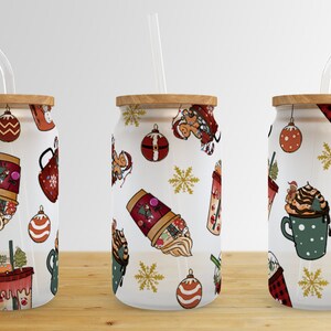 May include: Three white reusable tumblers with lids and straws. Each tumbler features a different Christmas-themed pattern with illustrations of coffee cups, ornaments, snowflakes, and gingerbread people.