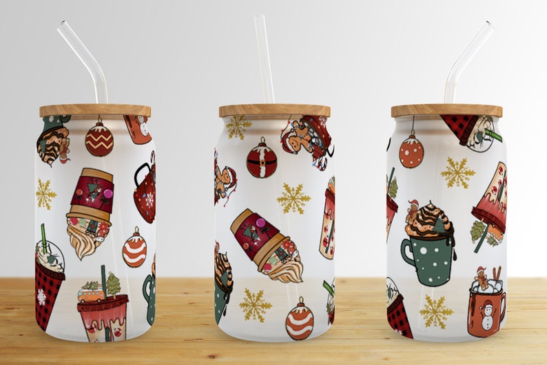 May include: Three white reusable tumblers with lids and straws. Each tumbler features a different Christmas-themed pattern with illustrations of coffee cups, ornaments, snowflakes, and gingerbread people.