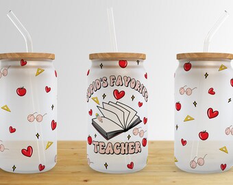 May include: Three clear glass tumblers with wooden lids and straws. The middle tumbler has a pink and white design with the text "Cupid's Favorite Teacher". The other two tumblers have a white background with red apples, hearts, and stars.